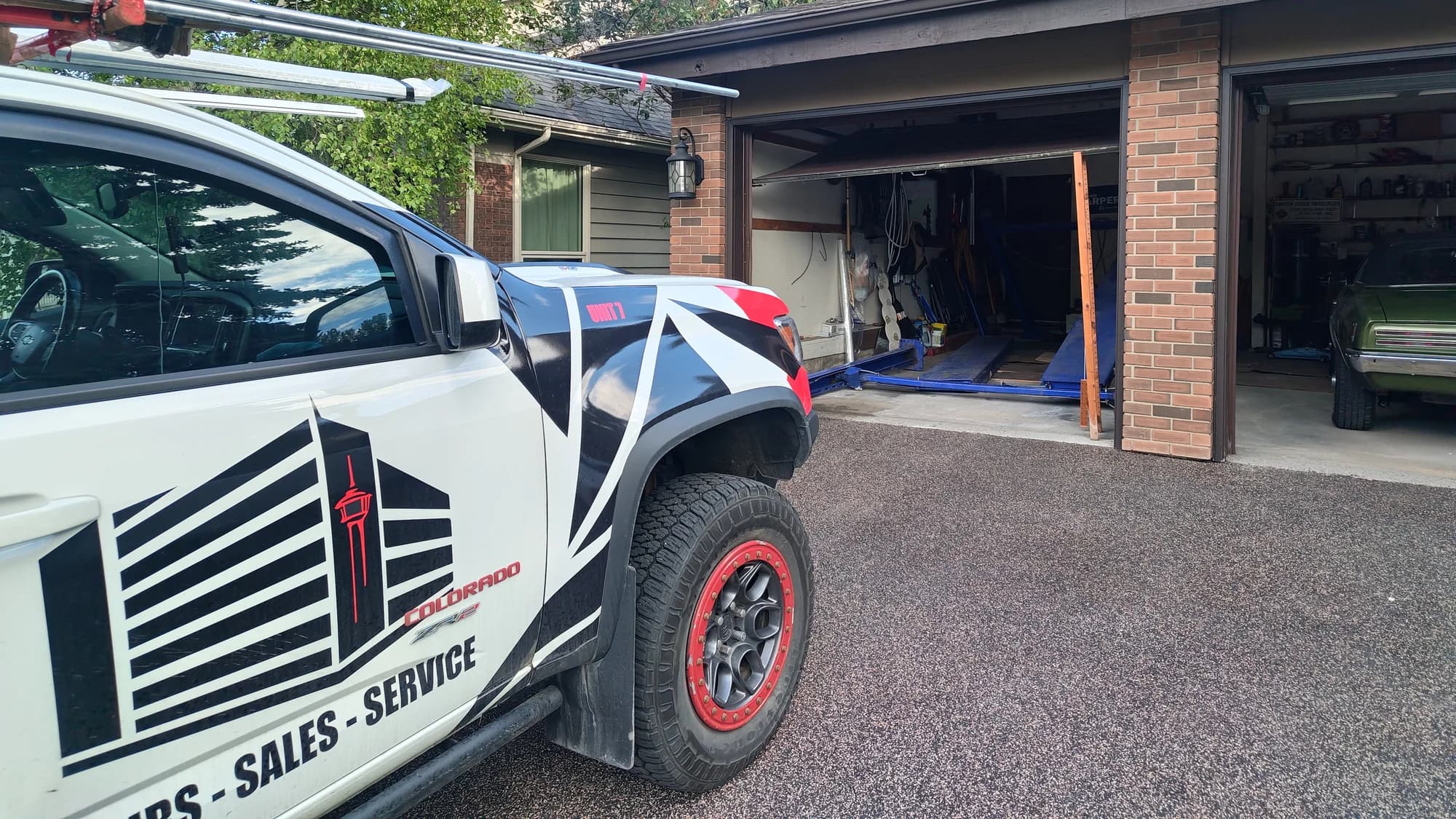 Garage Door Fix service truck outside a Canterbury Drive SW Calgary garage during a car lift collapse repair