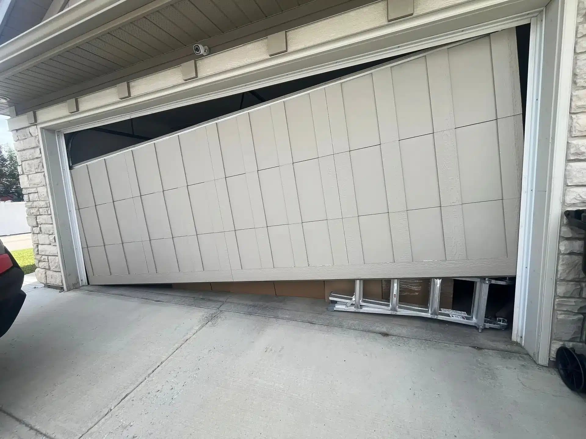 Broken garage door cable before repair — SW Calgary