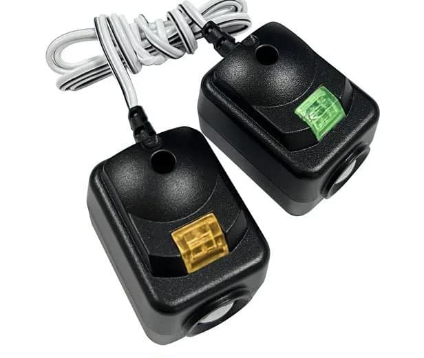 Garage door photo-eye safety sensor beside the track