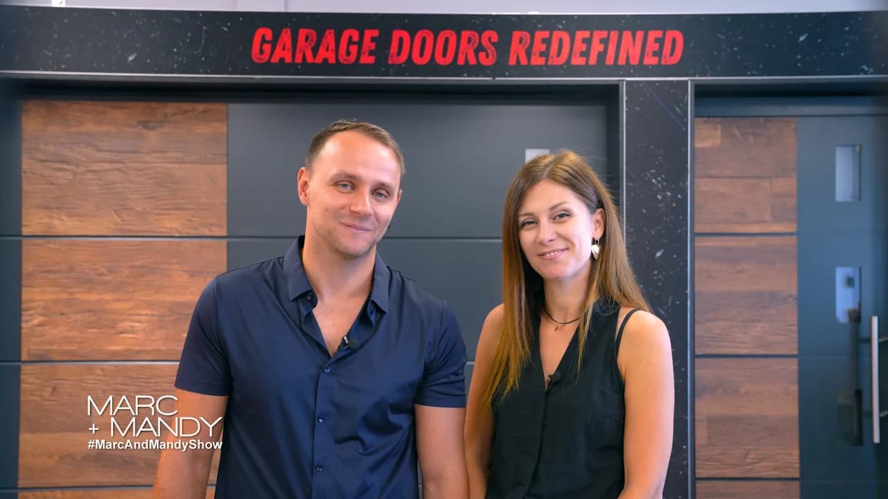 Stan and Marta Klugman together in front of Garage Door Fix display doors on The Marc & Mandy Show