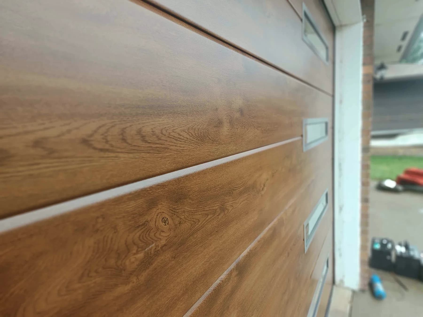 Old Oak wood-image finish and Midrib panel detail on a Ryterna garage door