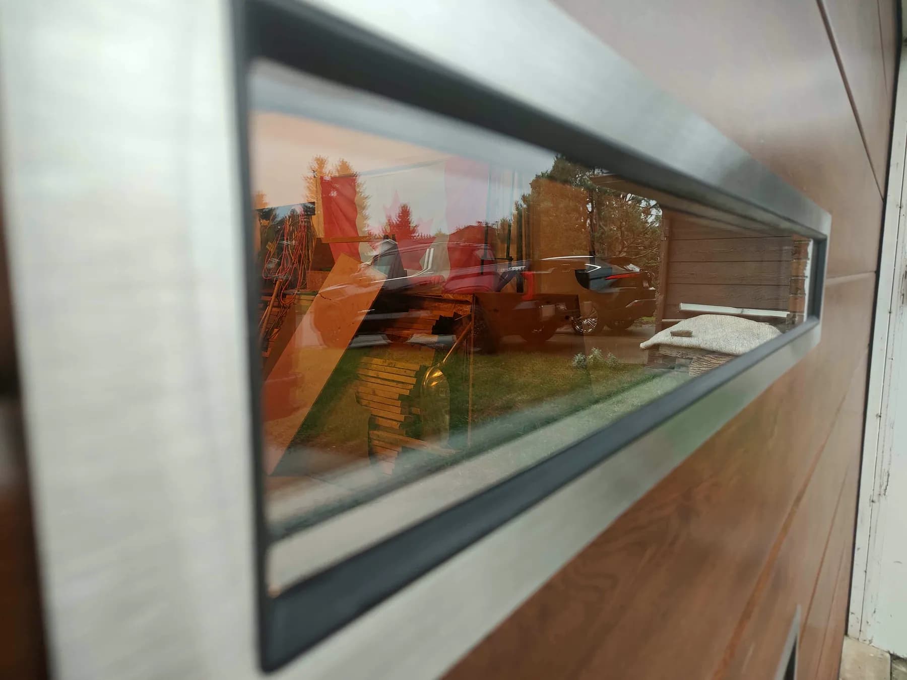 Angled close-up of a slim window and brushed stainless steel frame on an Old Oak Ryterna garage door