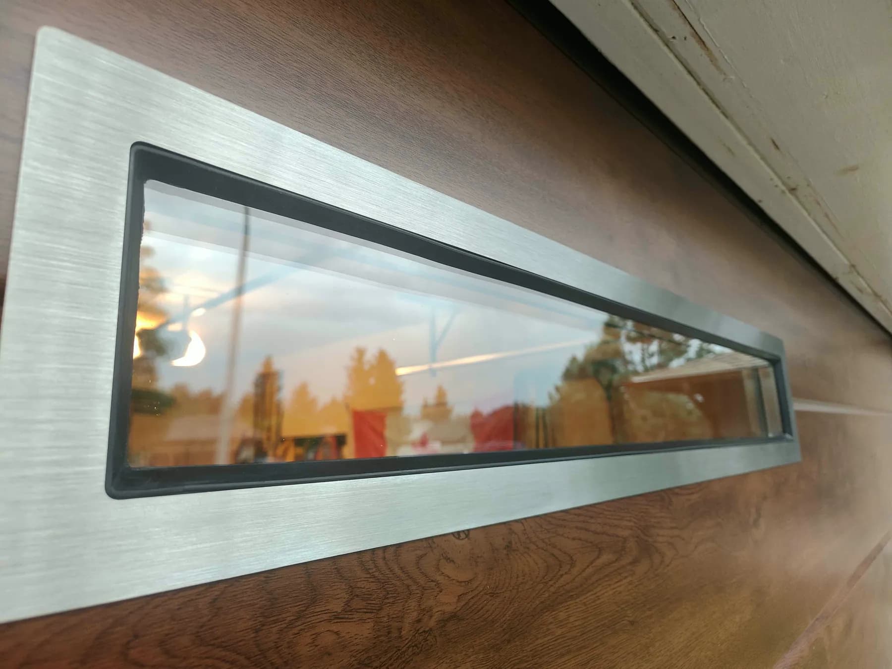 Close-up of the stainless steel frame around a slim Ryterna garage door window