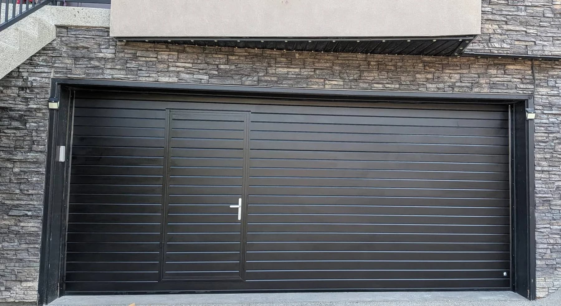 Ryterna Ribbed walk-through garage door in RAL 9004 Signal Black installed in Downtown Calgary