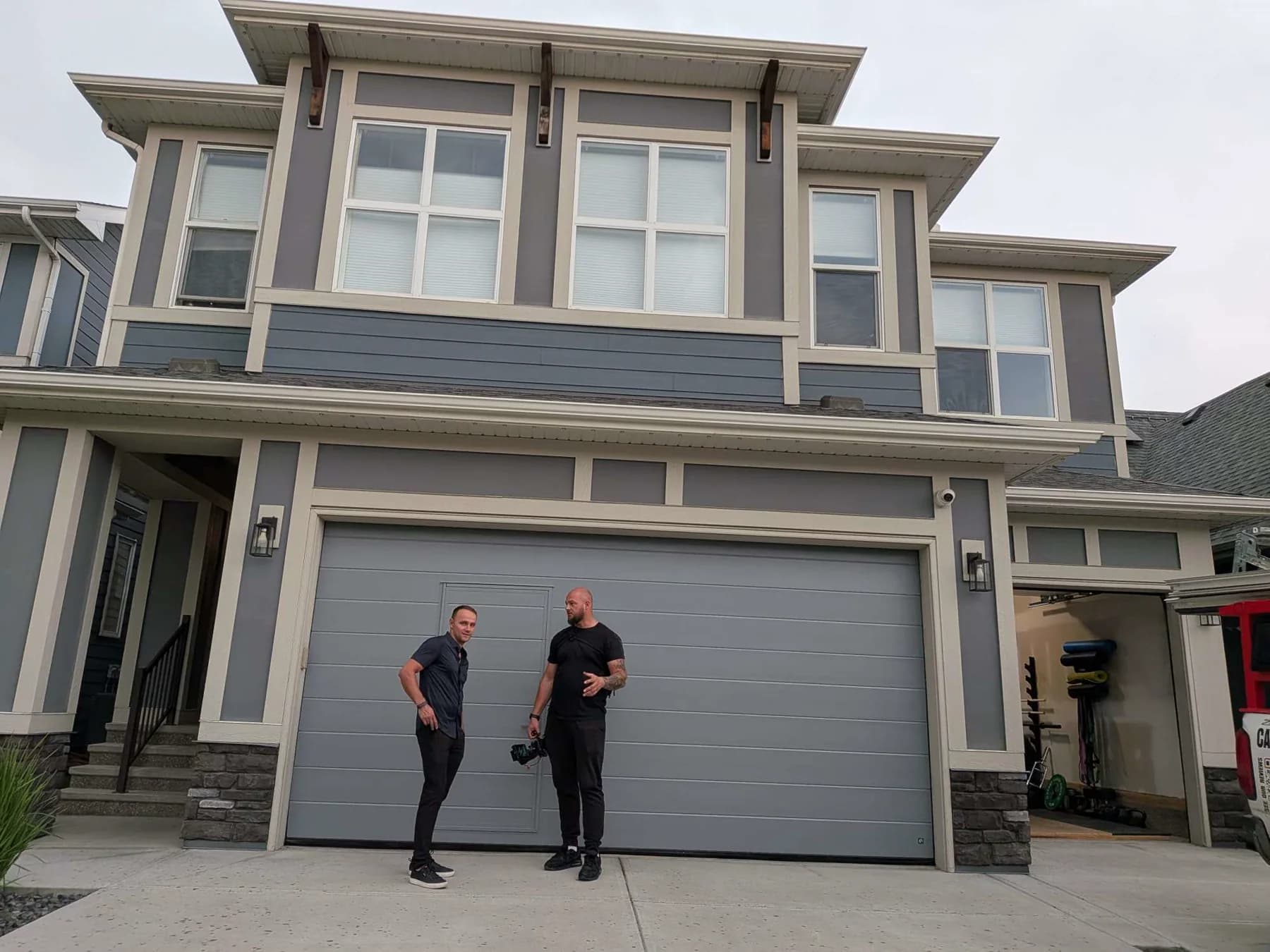 Garage Door Fix team documenting the completed Ryterna installation in Mahogany Calgary