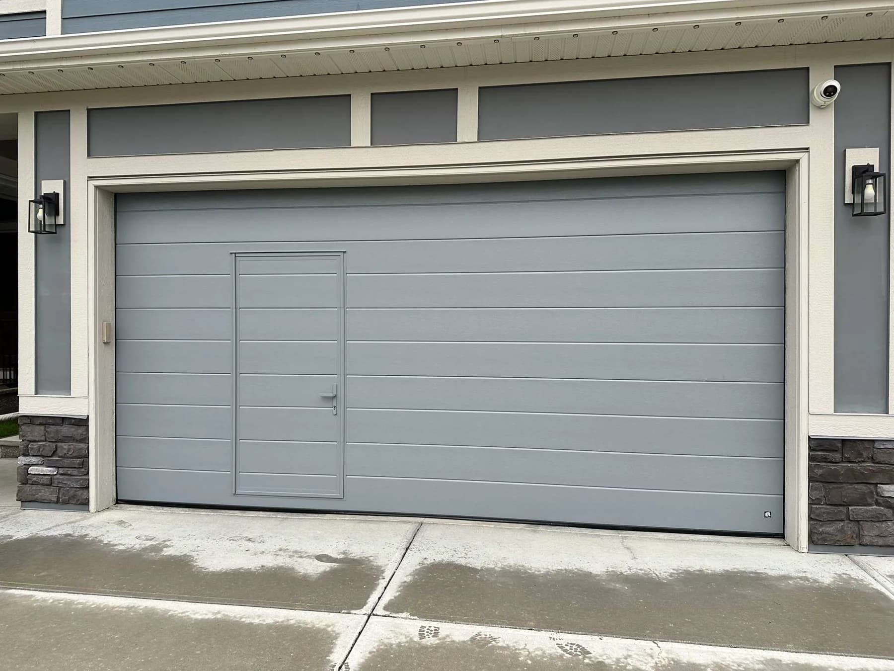 Ryterna Midrib walk-through garage door in RAL 7031 installed in Mahogany Calgary