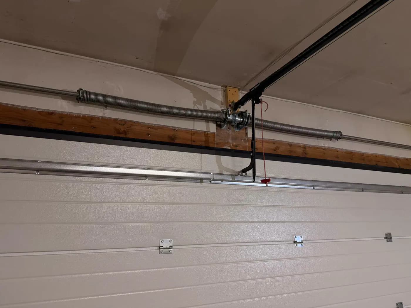 Ryterna torsion spring and centre bearing assembly above the installed Deer Run garage door
