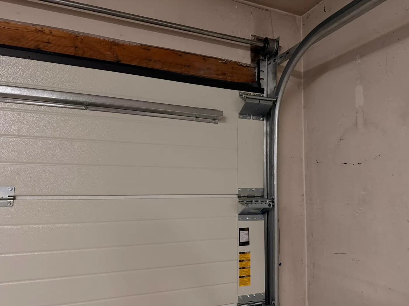 Ryterna side track roller bracket and panel hardware inside a Deer Run Calgary garage