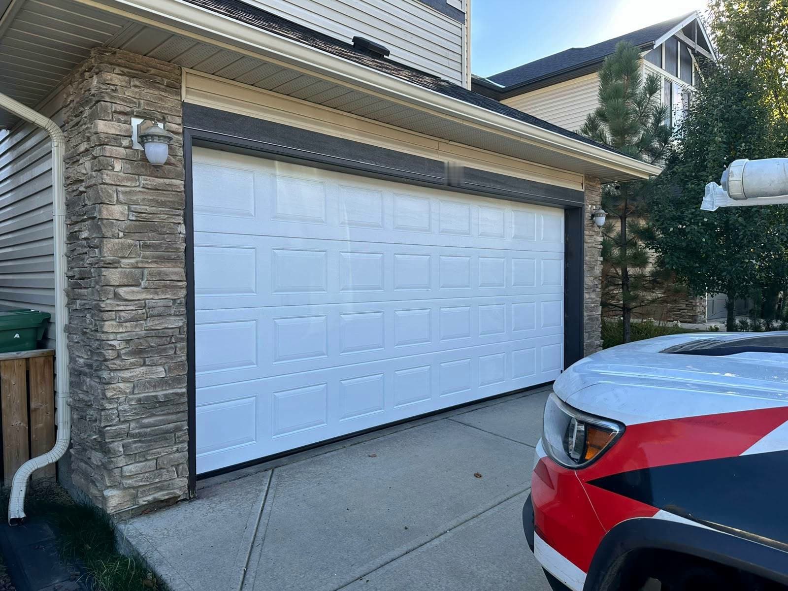White Ryterna Cassette garage door photographed from an angle after installation in Edmonton