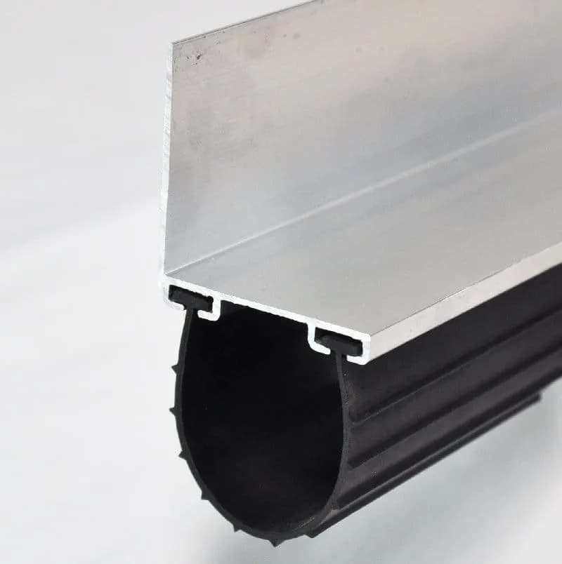 Flexible garage door bottom seal fitted into its lower channel