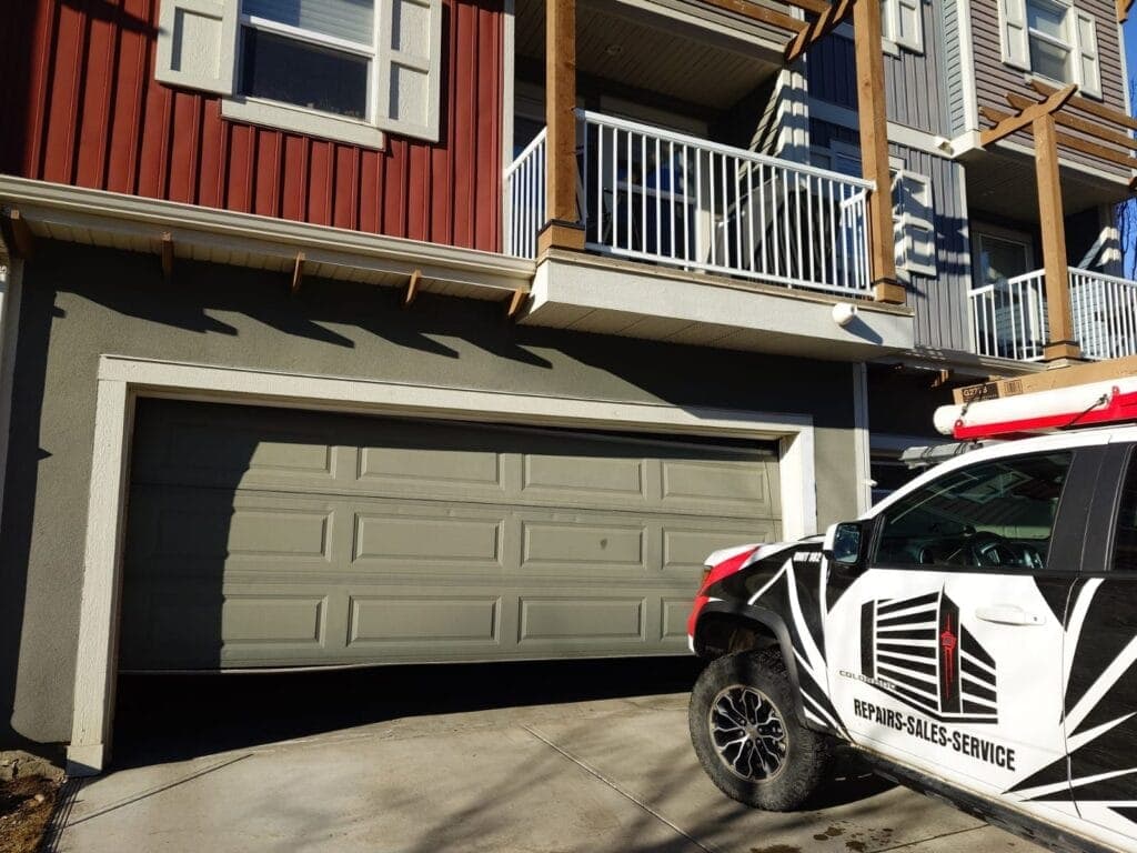Garage Door Fix technician inspecting a residential garage door system